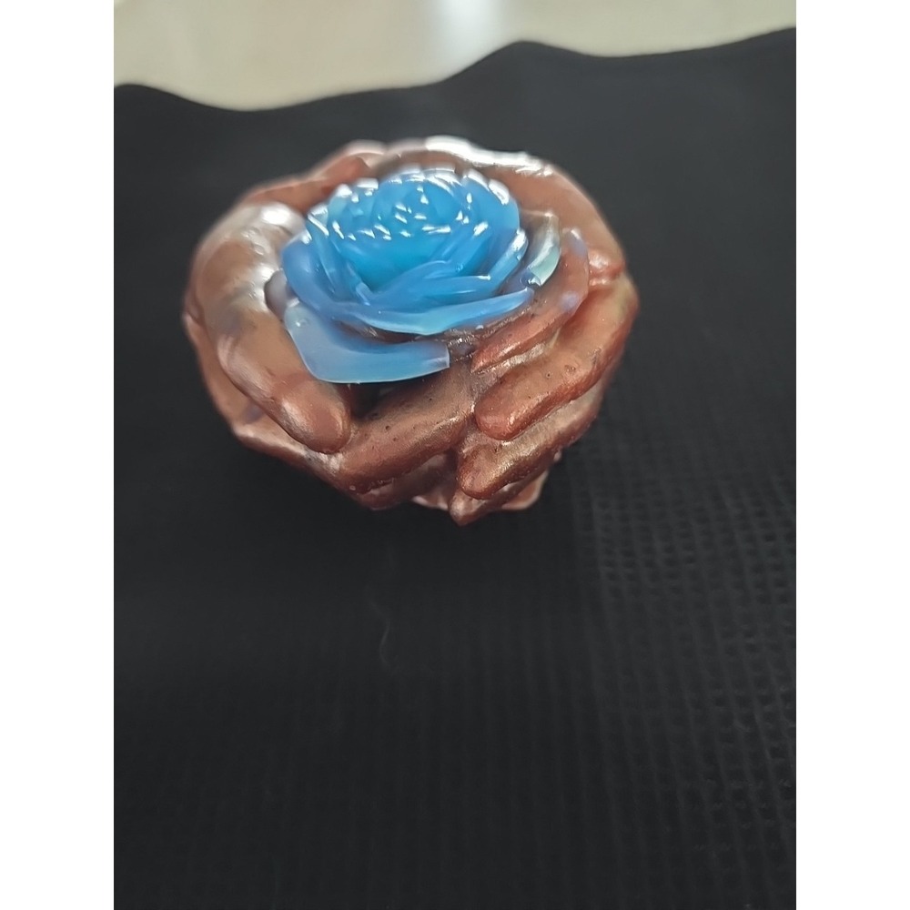 Resin Brown Hand Holding A Blue Flower.    562